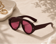 Load image into Gallery viewer, Oversized statement sunglasses with pink red tinted lenses and sculpted dark frame from Adore Her Sole.
